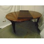 A Victorian shaped oval mahogany dining table with two drop in leaves and Joseph screw mechanism, by
