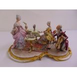A Crown Naples porcelain figural group of figures in a salon in 18th century style costume