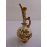 A Royal Worcester decorative jug with floral designs to the side and gilded mounts