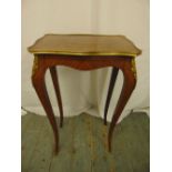 A rectangular Kingswood side table with applied gilded metal mounts on four cabriole legs