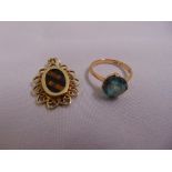 9ct yellow gold and tigers eye pendant and a 9ct yellow gold ring set with a blue stone