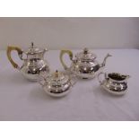 A four piece silver teaset of compressed spherical form with cut cardwork and double scroll