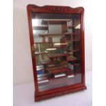 A wall mounted Oriental style miniatures display cabinet with mirrored back