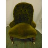A Victorian ladies button back upholstered chair on turned mahogany legs with original castors