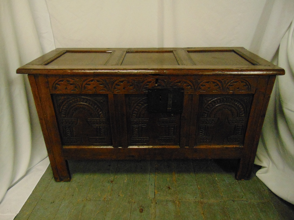 A rectangular oak chest panelled sides, hinged cover on four bracket feet