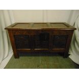 A rectangular oak chest panelled sides, hinged cover on four bracket feet