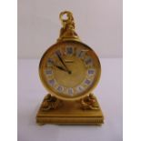 A French Luxor gilt mantle clock of circular form surmounted by a classical figurine, the