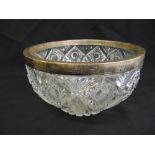 A circular cut glass fruit bowl with hallmarked silver collar