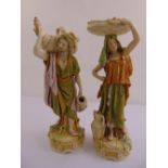 A pair of Royal Dux figurines of a lady and man carrying baskets and vases