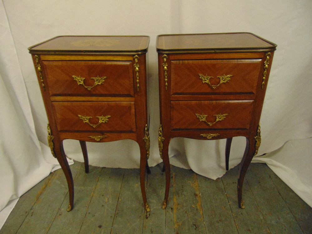 A pair of rectangular two drawer side tables with applied gilded metal mounts on four cabriole legs