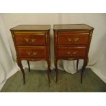 A pair of rectangular two drawer side tables with applied gilded metal mounts on four cabriole legs