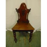 A Victorian mahogany hall chair, pierced back on turned baluster legs