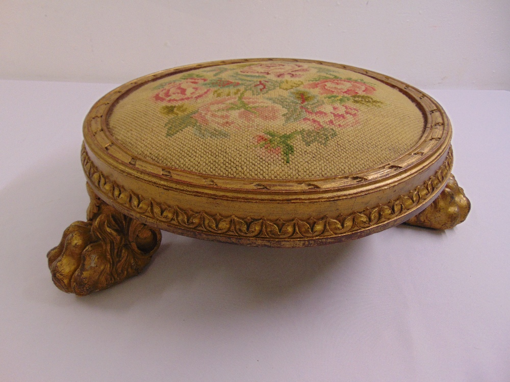 A Regency circular gilded wooden embroidered foot stool