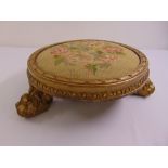 A Regency circular gilded wooden embroidered foot stool