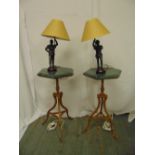 A pair of hexagonal marble top side tables on triform bases with spelter figural table lamps and