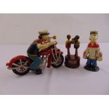 A cast iron painted figurine of Popeye riding a motorbike, a cast iron figurine of Popeye standing