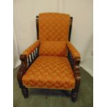 A Victorian mahogany upholstered armchair with galleried arms on turned cylindrical legs