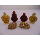 A quantity of oriental composition scent bottles of various shape and form and two figural group