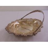 A silver shaped oval cake basket, pierced sides chase with flowers and leaves and pierced swing