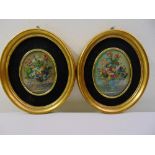 A pair of miniature framed and glazed oval still life oil paintings of flowers, 10 x 7cm each