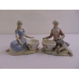 Lladro a pair of figural groups of a boy and girl seated, marks to the bases