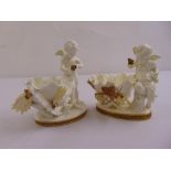 Two Moores porcelain figural groups with putti on raised oval bases A/F