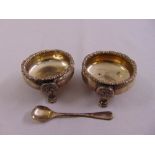 A pair of silver salts and a condiment spoon