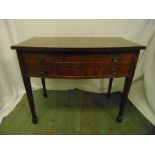 A rectangular mahogany two drawer table with brass handles on tapering rectangular legs