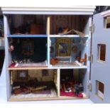 A modern doll's house fitted with various furnitur