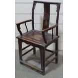 An Antique Chinese stained elm elbow chair, with carved back