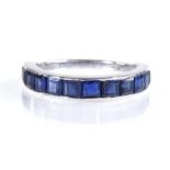 An 18ct white gold square-cut sapphire half eternity ring, setting height 3.6mm, size K, 3g