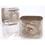 A pair of Victorian square silver napkin rings, with engraved floral decoration and applied gold
