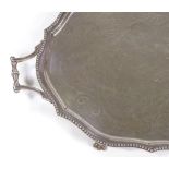 A large silver plated oval tray, with beaded edge and claw and ball feet, length 72cm