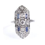 An Art Deco sapphire and diamond cluster panel ring, unmarked platinum setting, with pierced bridge,