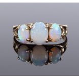 A 9ct gold 3-stone cabochon opal ring, with pierced heart design shoulders, setting height 8.1mm,