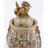 A Japanese Satsuma porcelain pot and cover, with painted figures surmounted by a gilded dragon,