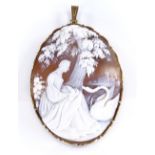 A relief carved cameo pendant, depicting a lady with a swan, in rolled gold frame, height 59mm