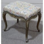A carved giltwood framed dressing stool, circa 1900, with upholstered seat and cabriole legs