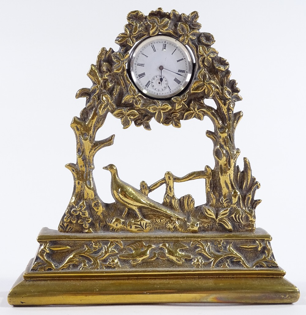 A 19th century brass pocket watch stand, with pheasant design, containing a silver-cased top-wind
