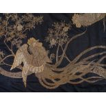 An early 20th century Oriental silver braid embroidered cotton wall hanging, decorated with