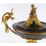 A large ornate French gilt-bronze mounted urn and cover, surmounted by a figure of a cherub,