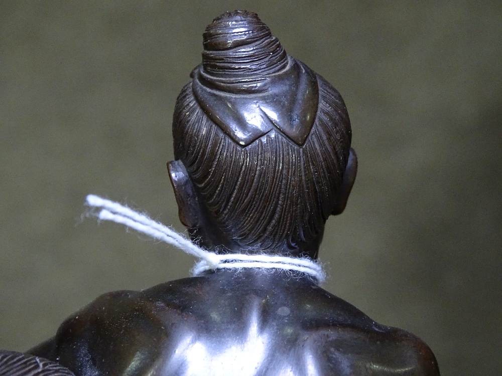 A Japanese bronze Sumo wrestling sculpture, early 20th century, unsigned, on circular ebony stand, - Image 9 of 9