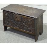 A small Antique joined-oak coffer of plank construction, with chip carved floral decorated front,