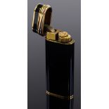 A Cartier gold plate and black lacquer pocket lighter, boxed
