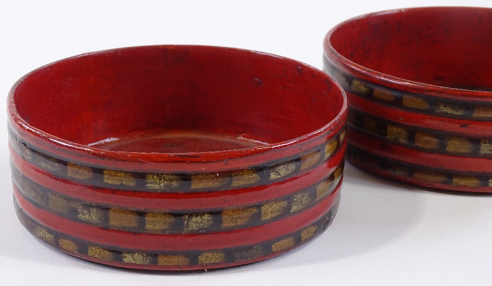 A pair of Regency papier-mache wine coasters with reeded surrounds, diameter 13.5cm