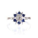 An 18ct white gold sapphire and diamond cluster ring, setting height 9.8mm, size L, 3.6g