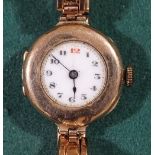 A lady's Vintage 9ct gold mechanical wristwatch, with gilded enamelled dial and 9ct expanding strap