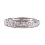 A 9ct white gold diamond cluster half eternity ring, setting height 3.7mm, size R, 2.1g