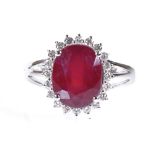 A 14ct white gold ruby and diamond cluster ring, oval-cut ruby approx 4.72ct, total diamond