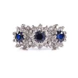 An 18ct gold sapphire and diamond triple cluster ring, setting height 9.3mm, size O, 5.8g